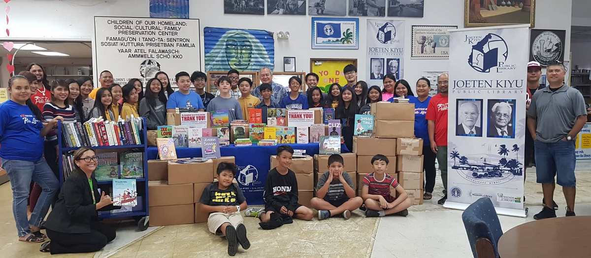 U.S. Congressman Gregorio Kilili Camacho Sablan on Thursday donated 51 boxes of books to Joeten-Kiyu Public Library. Photo shows Kilili with Northern Marianas International School students and JKPL staff members. Photo by Lori Lyn C. Lirio