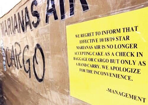 No cakes allowed. A sign at the Tinian airport cargo desk lets passengers know they can’t ship cakes as cargo. Photo by Brad Lendon CNN