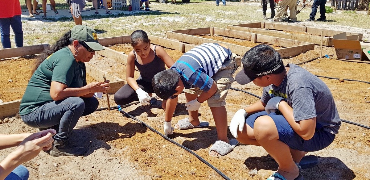 Board of Parole Chairman Ramon B. Camacho, right standing, talks during the gardening workshop at Kanoa Resort on Saturday. Photo by Bryan Manabat