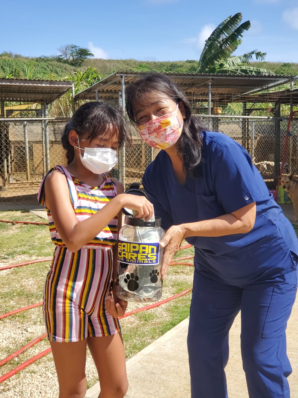 Saipan Cares for Animals vice president Yumiko Brundidge receives $773 from 9-year-old Kate King Manglona, who raised $443 by selling prints of her watercolor, Frank. Various donations collected by Marianas Creations added $300 to the pot, for a total of $773 donated to Saipan Cares.Contributed photo