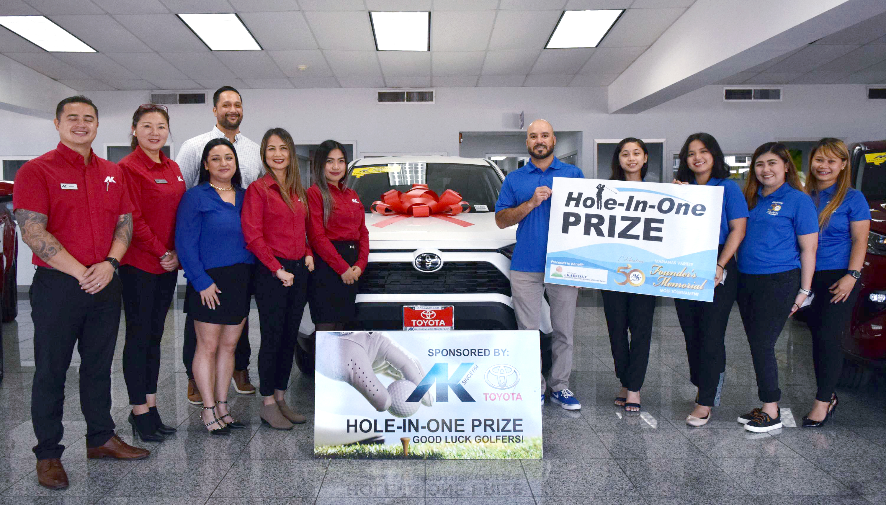 Atkins Kroll Sales Manager Kevin Barnes, back row, joins AK salespersons Kevin Ada, Kim Calage, Nicole Sablan, Liza Taylor and Didi Woodruff as they present a ceremonial hole-in-one prize donation to Marianas Variety President Amier Younis, fifth right, and MV sales representatives Monique Mascarinas, Hazel Nichole Sadian, Gwendolyn Sandig, Diane Lumapas.