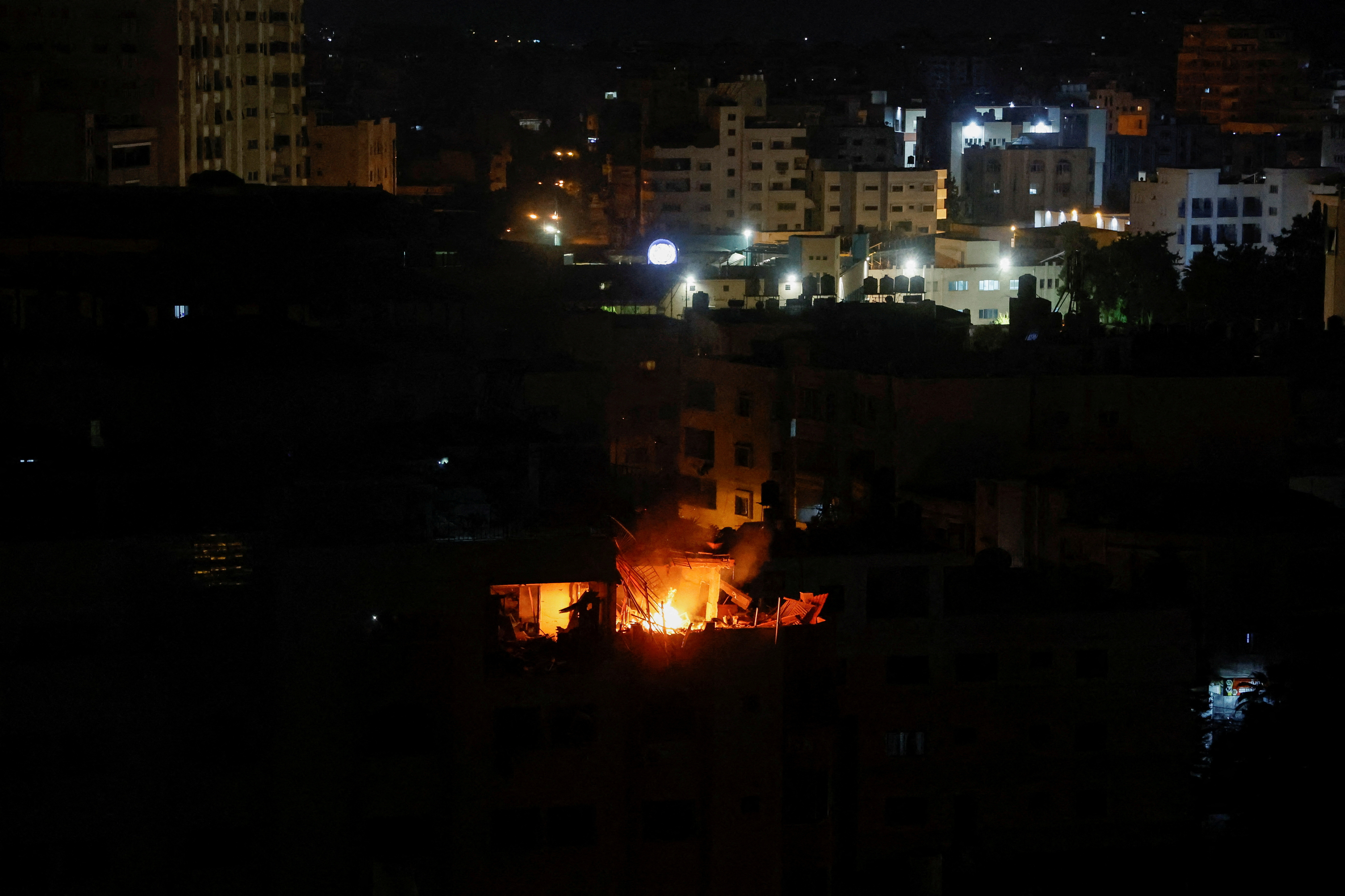 A fire burns in a building after the Israeli military struck Islamic Jihad targets, it said in a statement, in Gaza, May 9, 2023. REUTERS/Mohammed Salem