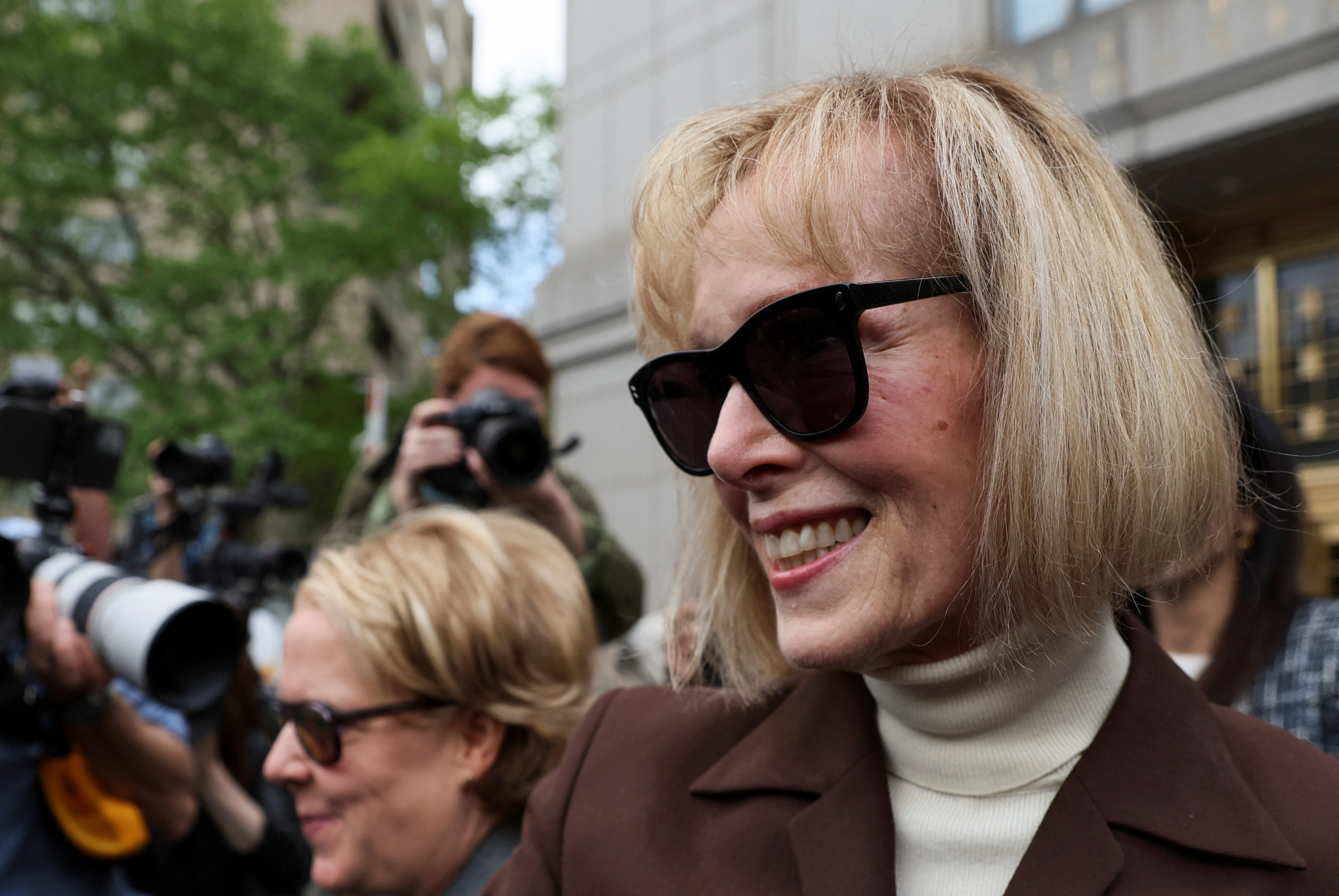 E. Jean Carroll reacts as she exits the Manhattan Federal Court following the verdict in the civil rape accusation case against former U.S. President Donald Trump, in New York City, U.S., May 9, 2023. REUTERS/Brendan McDermid