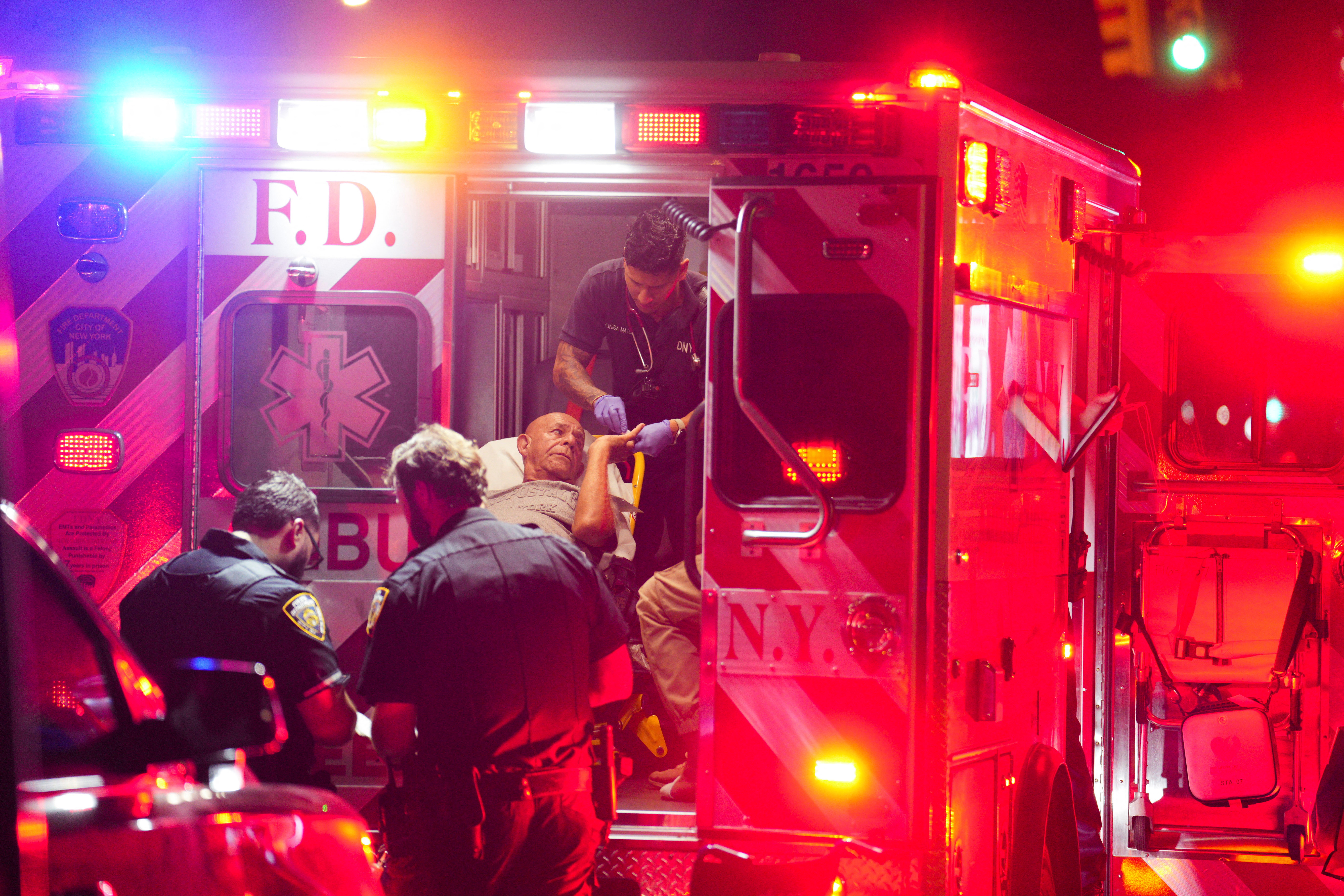 A man receives medical assistance at the site of a bus crash between a tourist double decker bus and a city bus in the Manhattan borough of New York City, U.S., July 6, 2023. REUTERS/Jeenah Moon
