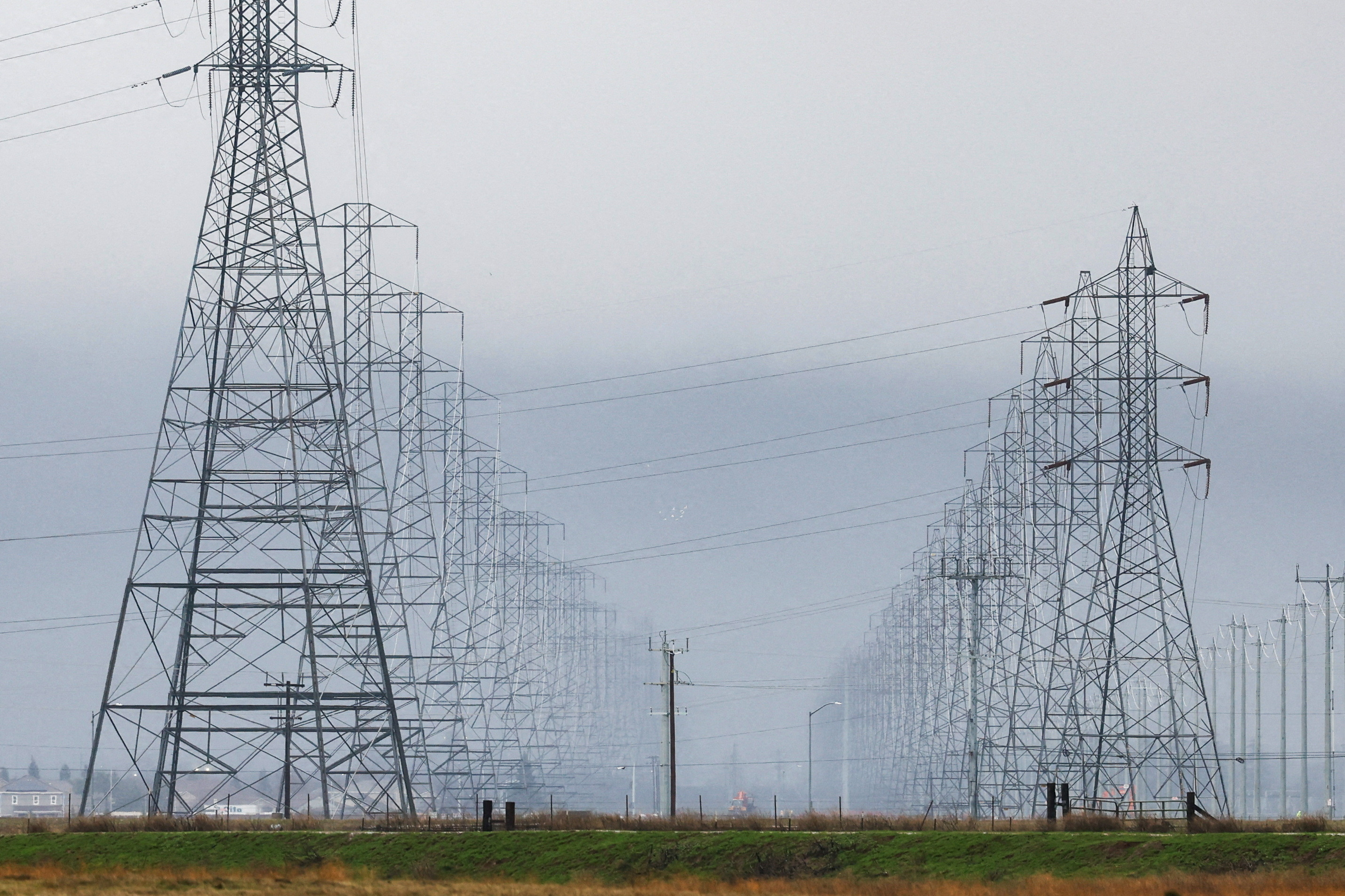 High tension power lines with winter storm clouds behind them are seen in Sacramento County following multiple winter storms in Sacramento, California, U.S. January 9, 2023. REUTERS/Fred Greaves