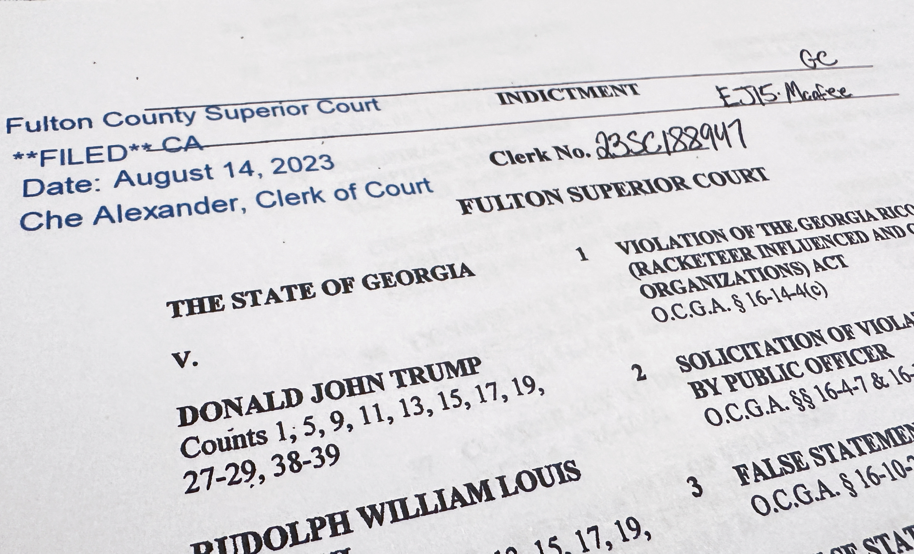 The first page of a 98-page grand jury indictment listing 19 defendants and 41 criminal counts, including felony charges of racketeering against former U.S. President Donald Trump, is seen after being released by Fulton County District Attorney Fani Willis and the Fulton County Superior Court in Atlanta, Georgia, U.S. August 14, 2023. REUTERS/Jim Bourg