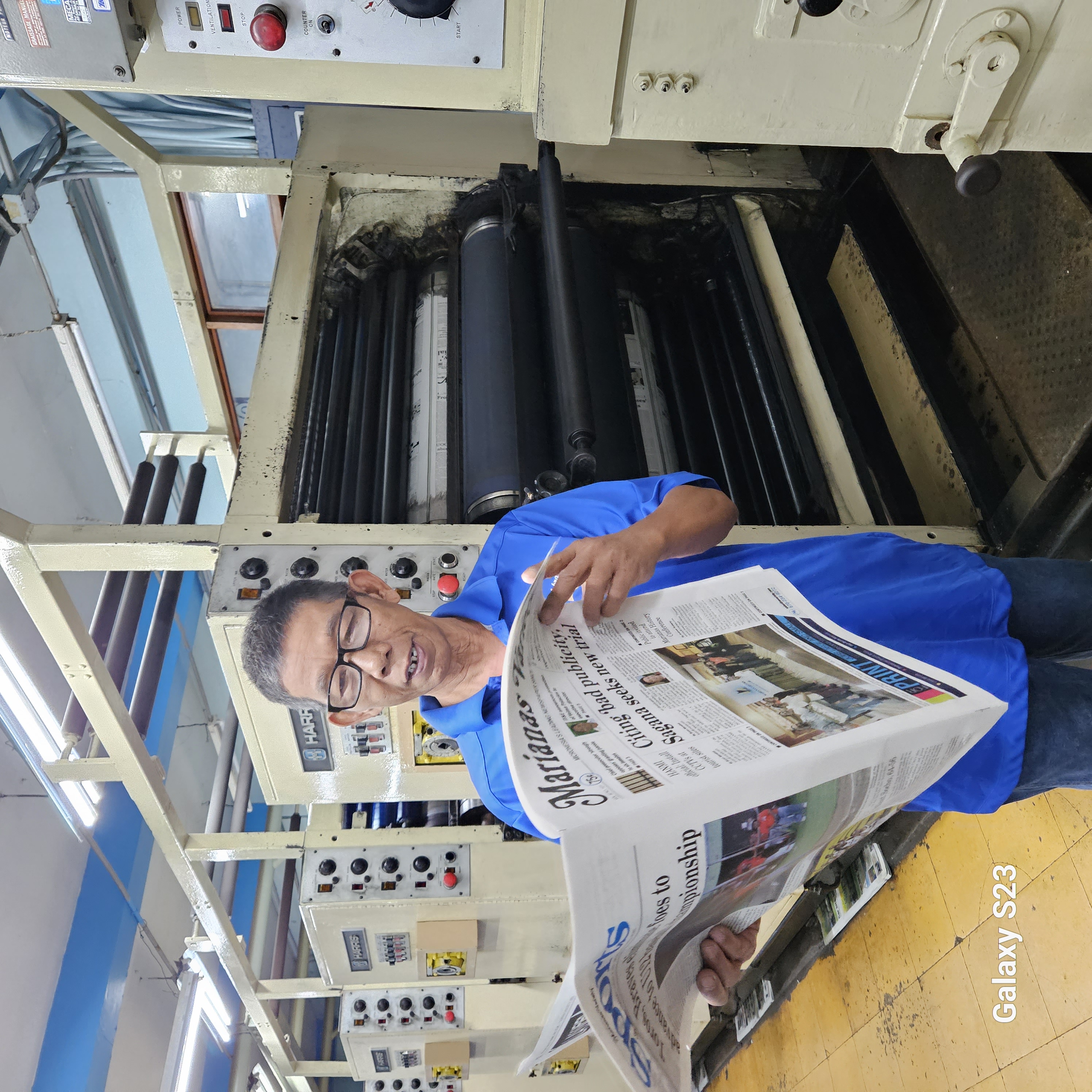 Arsenio Hembra reviews one of the daily papers he prints at Mvariety on August 31, 2023. 