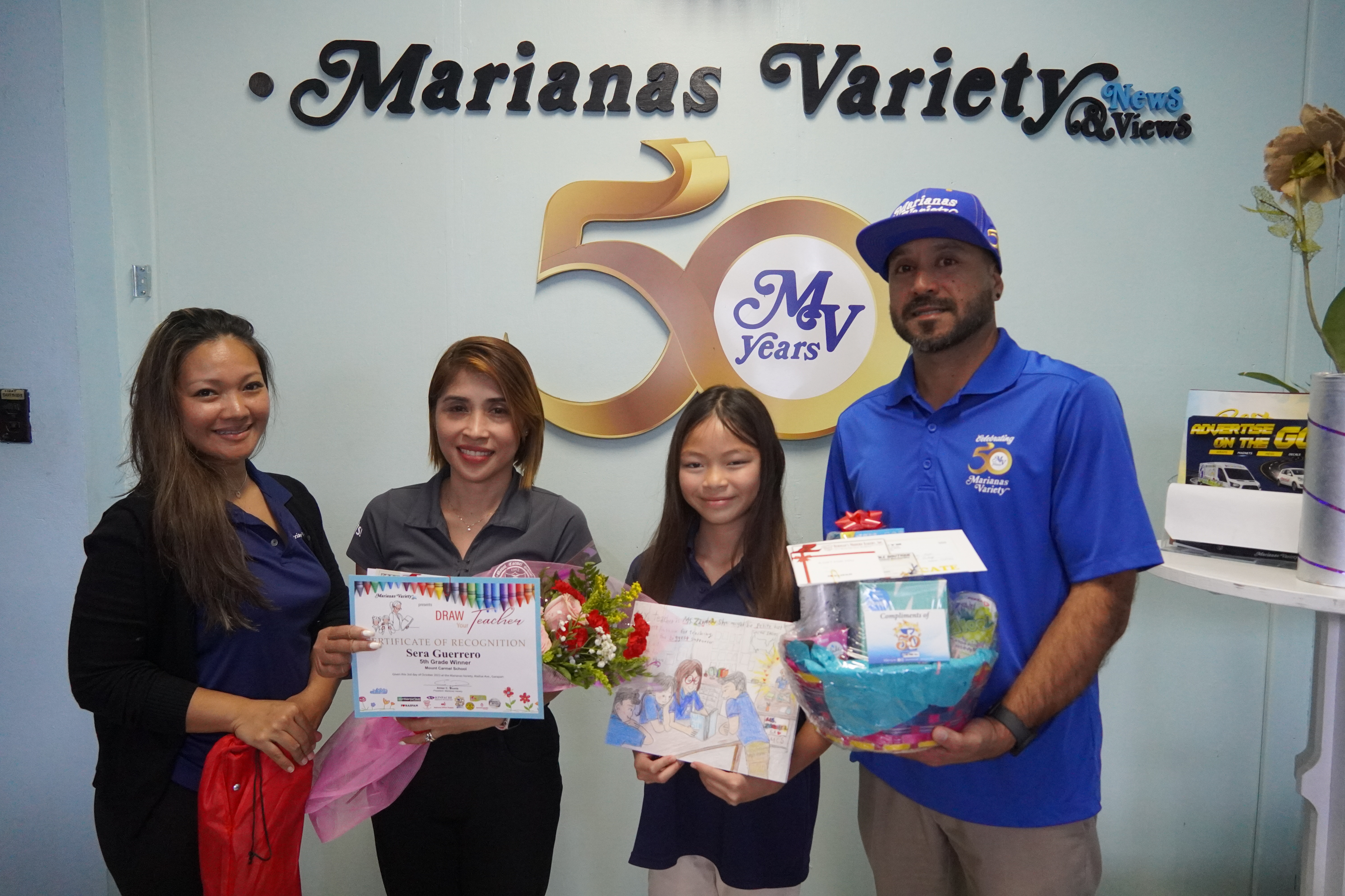 Fifth grader, Sera Guerrero, poses with her amazingly defined artwork and prize packages for her and her teacher.