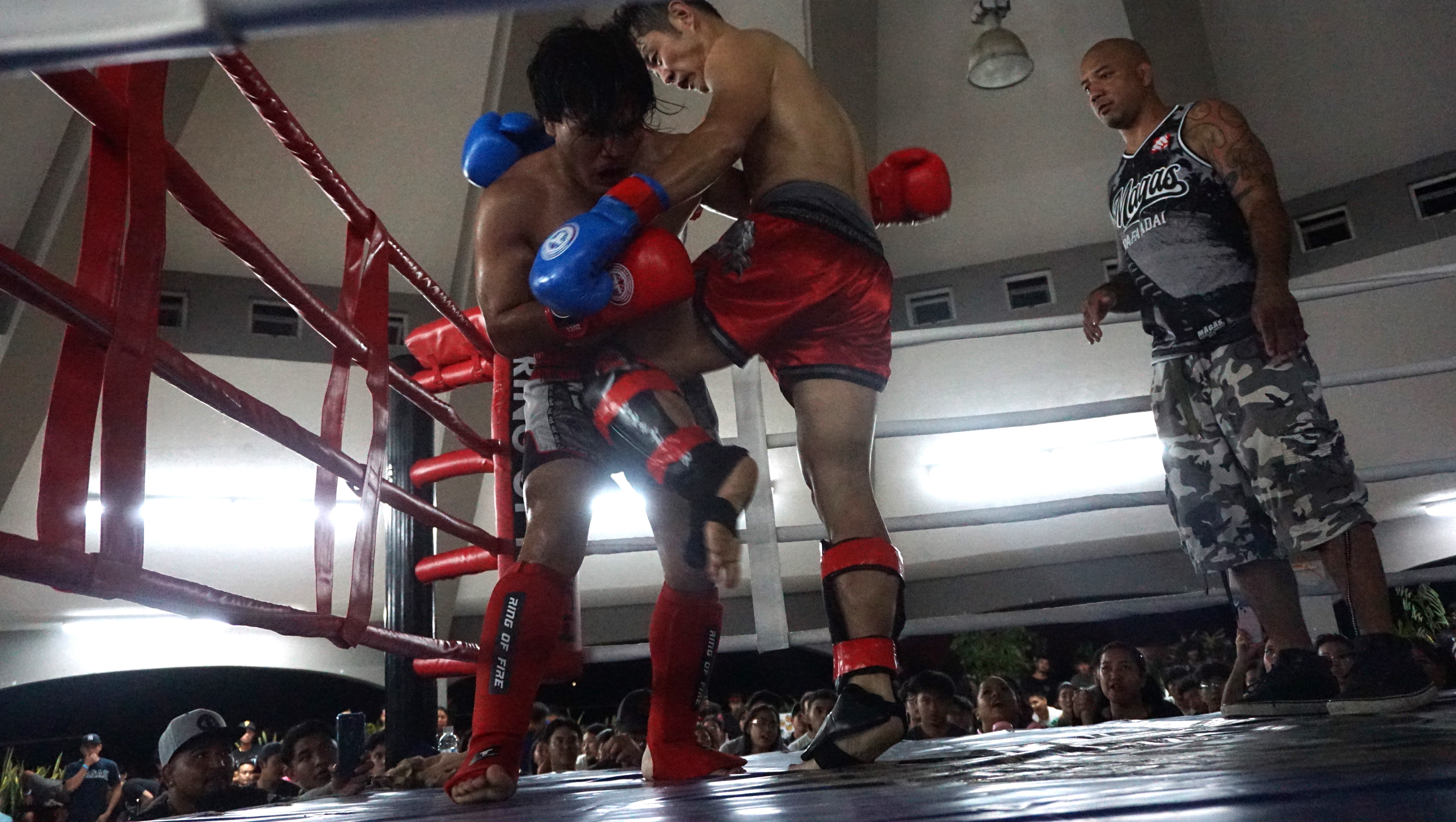 John Lee connects a knee in the clinch against Mike Camacho during their Ring of Fire kickboxing match  at the Garapan Central Park round house on Saturday.