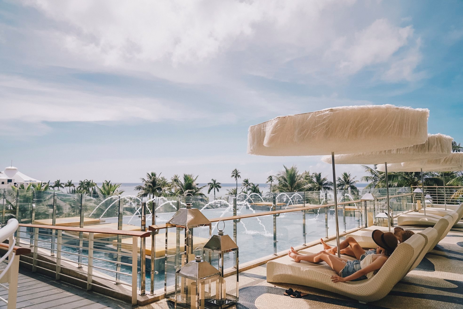 Guests enjoying a relaxed atmosphere under canopies at Kensington Hotel.