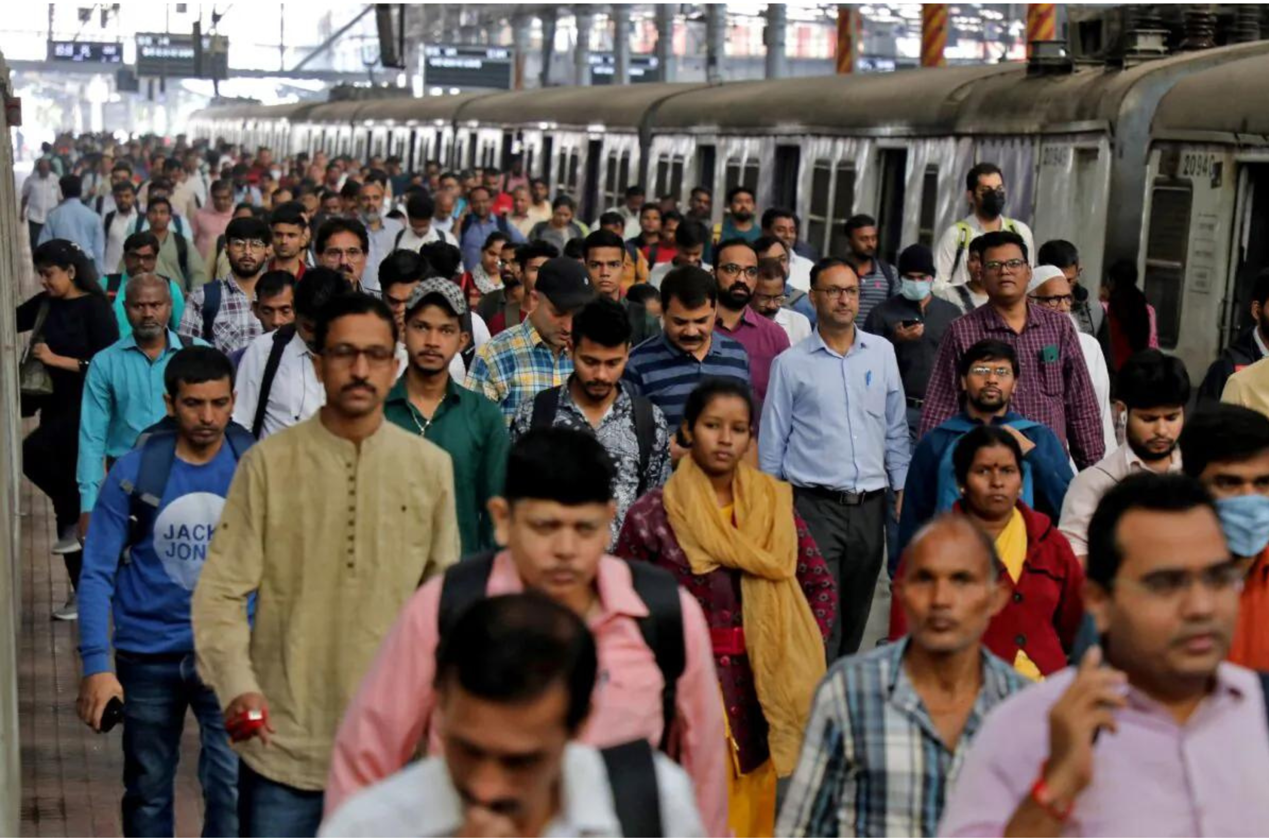 Commuters walk on a platform after disembarking from a suburban train at a railway station in Mumbai, India, on Jan. 21, 2023. (Niharika Kulkarni/Reuters)
