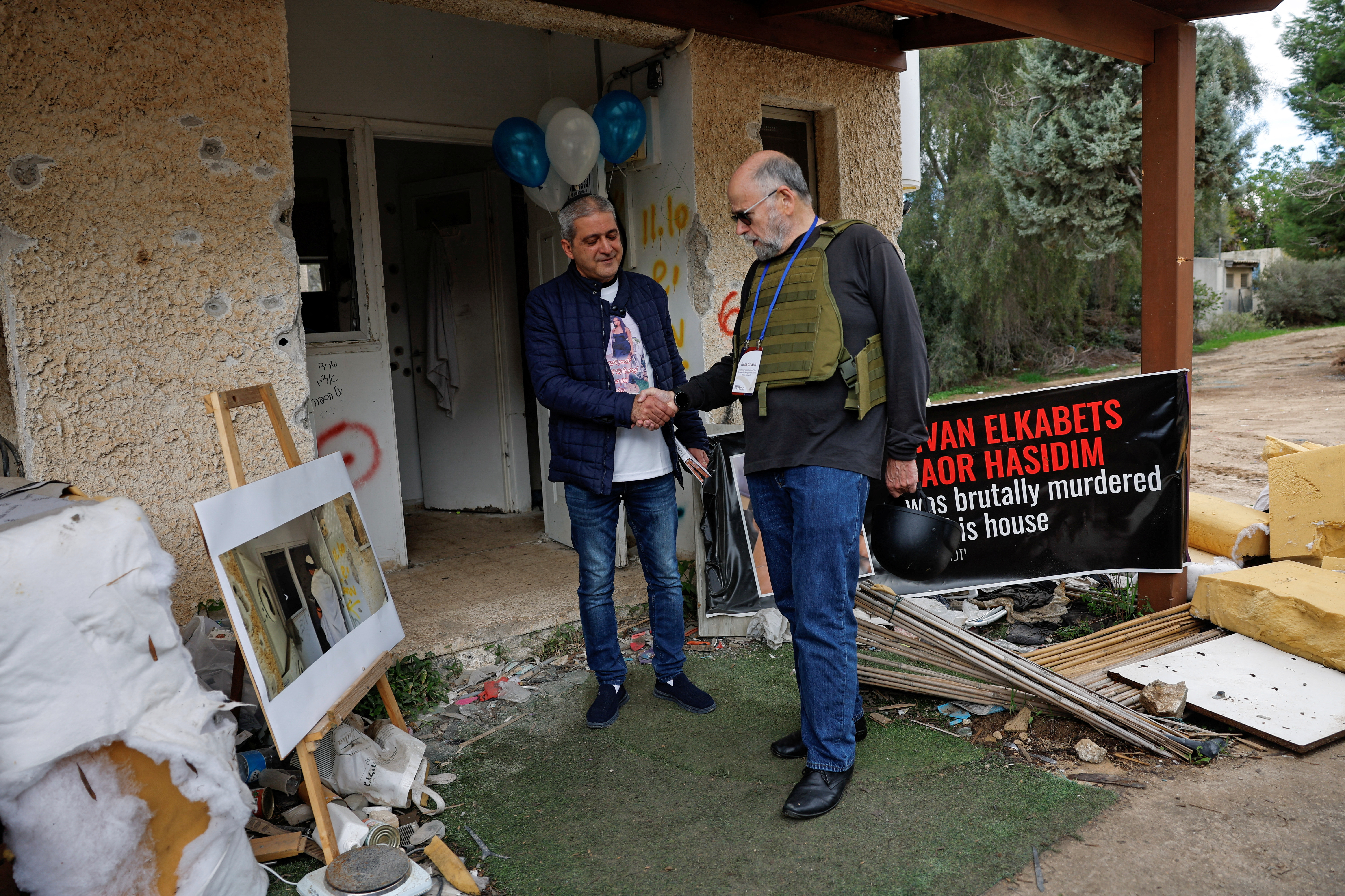 University professor Ram Cnaan meets Avi Hasidim whose son, Naor Hasidim, was killed during the deadly October 7 attack by gunmen from Palestinian Islamist group Hamas, during a visit by faculty from the University of Pennsylvania to Kibbutz Kfar Aza, in southern Israel January 3, 2024. 