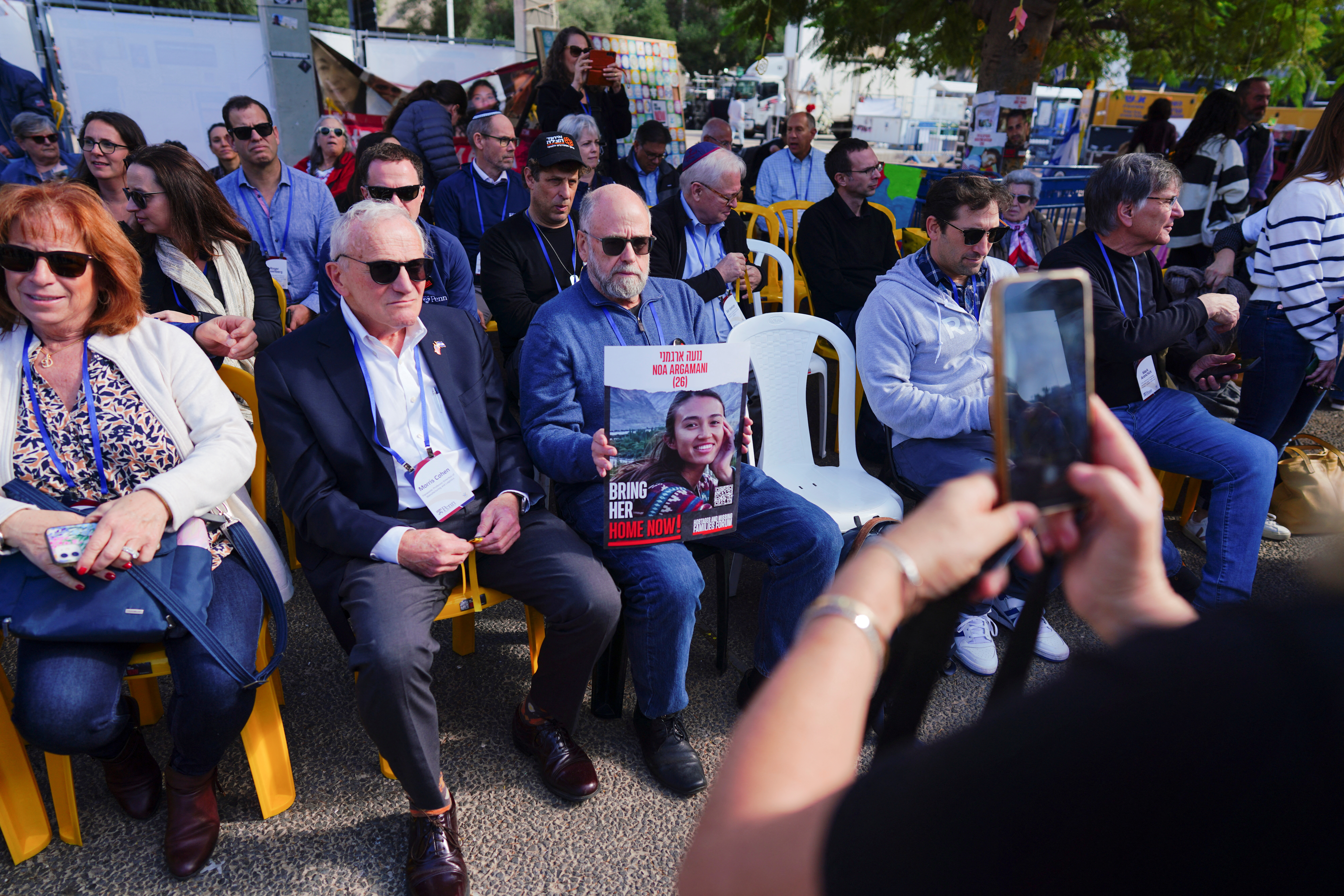 A member of the delegation from the University of Pennsylvania poses for photograph with a placard depicting one of the hostages, as they visit a plaza in support of the families of hostages kidnapped on the October 7 attack by Palestinian Islamist group Hamas, amid the ongoing conflict between Israel and Hamas, in Tel Aviv, Israel, January 4, 2024. 