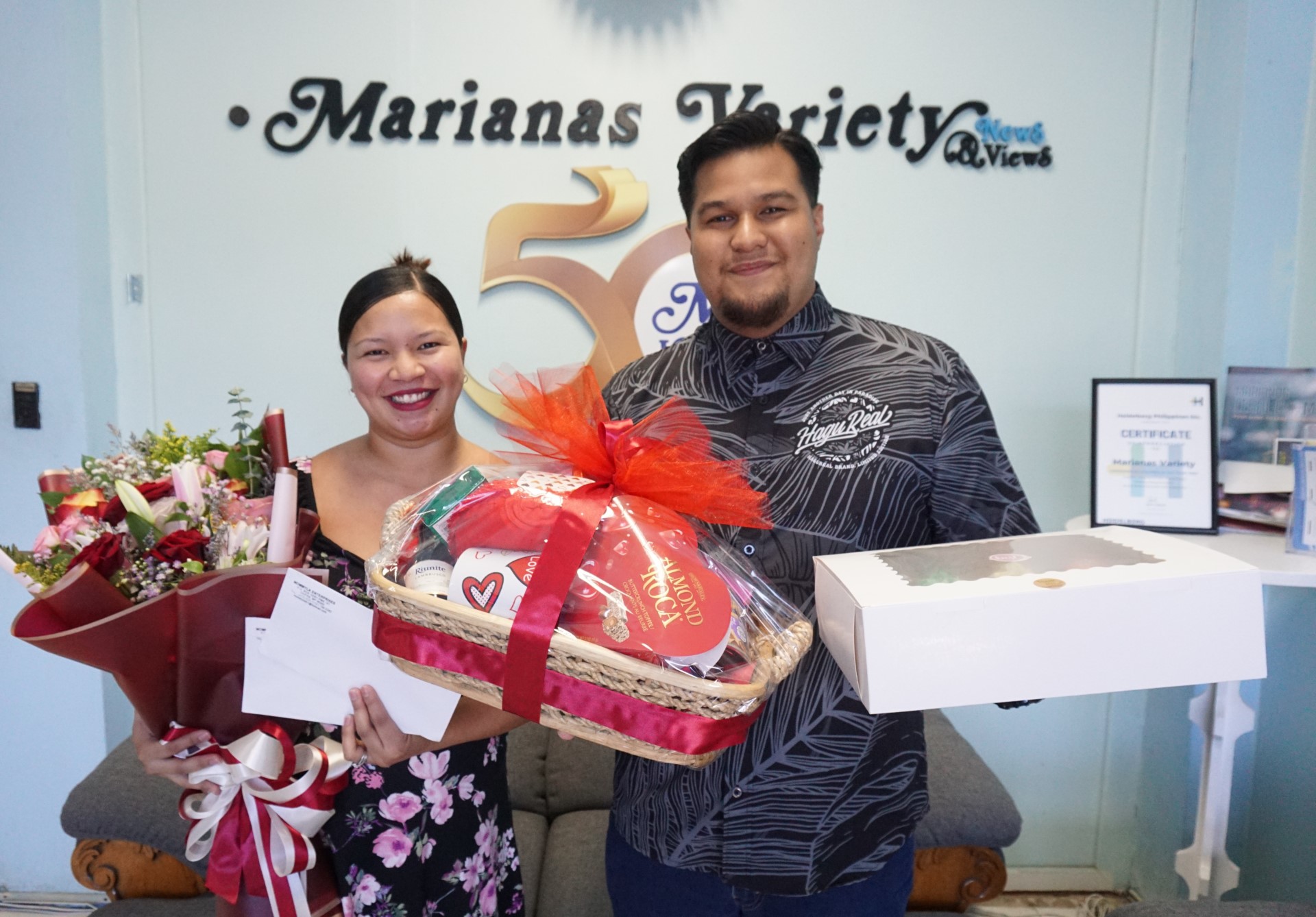 Joni, left, and Kevin hold the prizes they won as part of the Marianas Variety Valentine's Day contest.