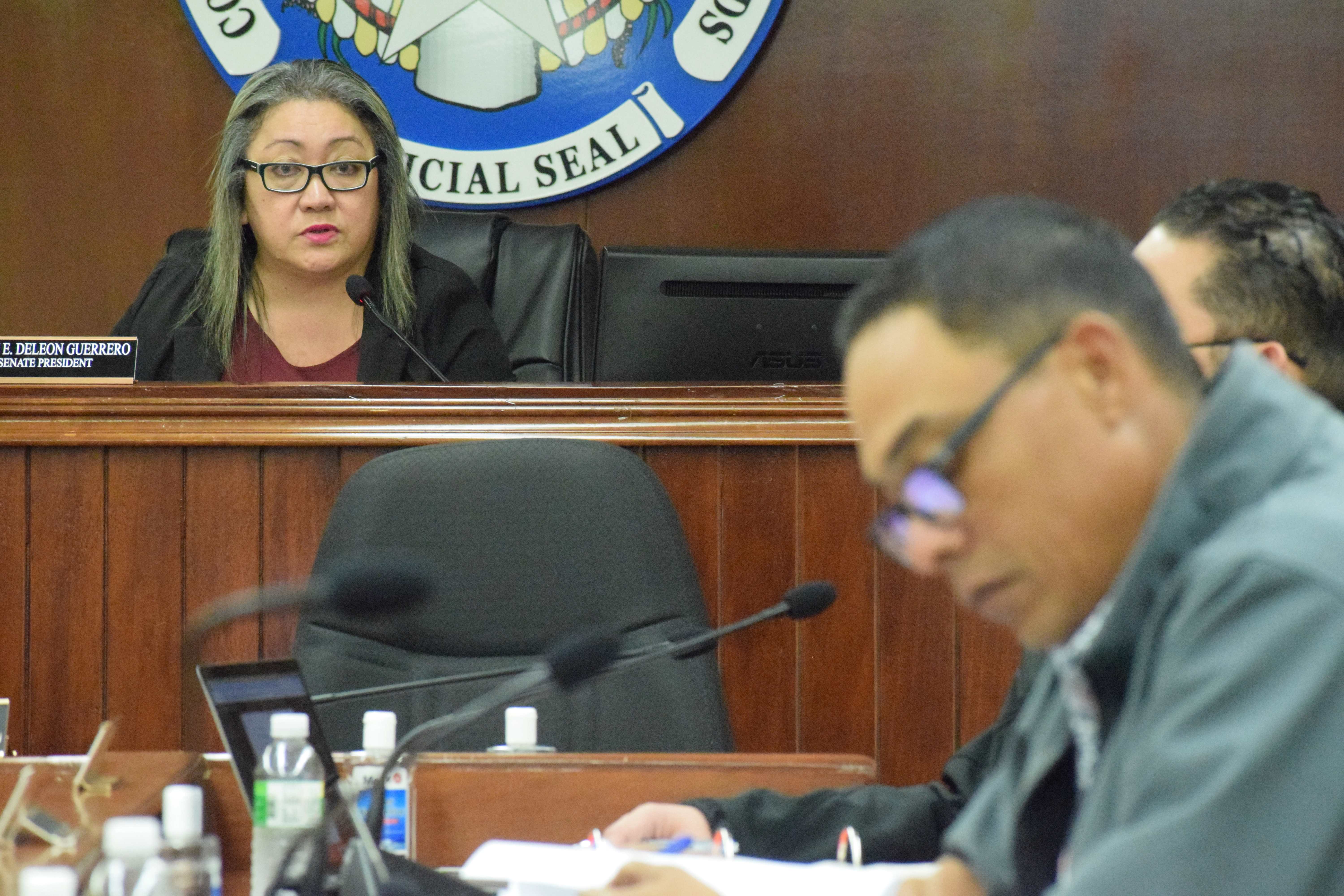 Senate President Edith Deleon Guerrero, left, speaks as Sen. Dennis Mendiola reviews his notes during a session on Monday.
