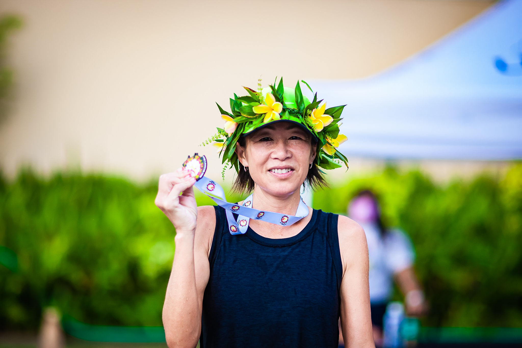 Noriko Jim shows one of her medals.