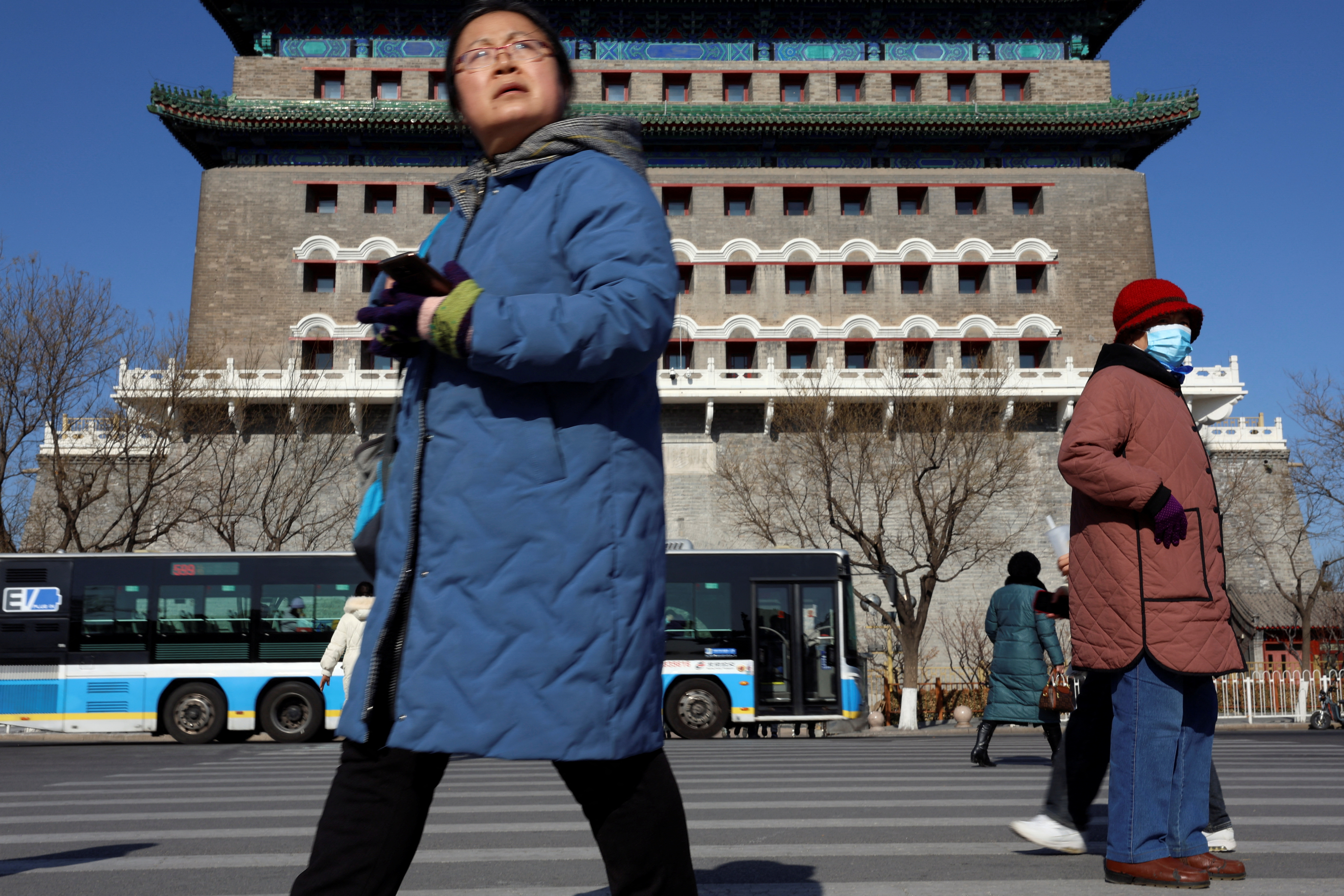 Pedestrians walk on a crossing near the Qianmen Gate in Beijing, China on January 26, 2024. 