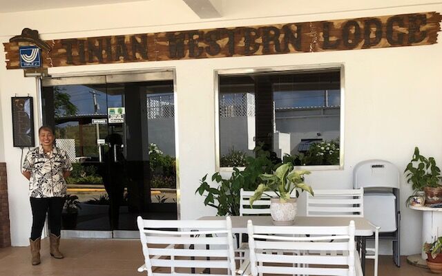 Dolore Kiyoshi poses at the entrance of Tinian Western Lodge