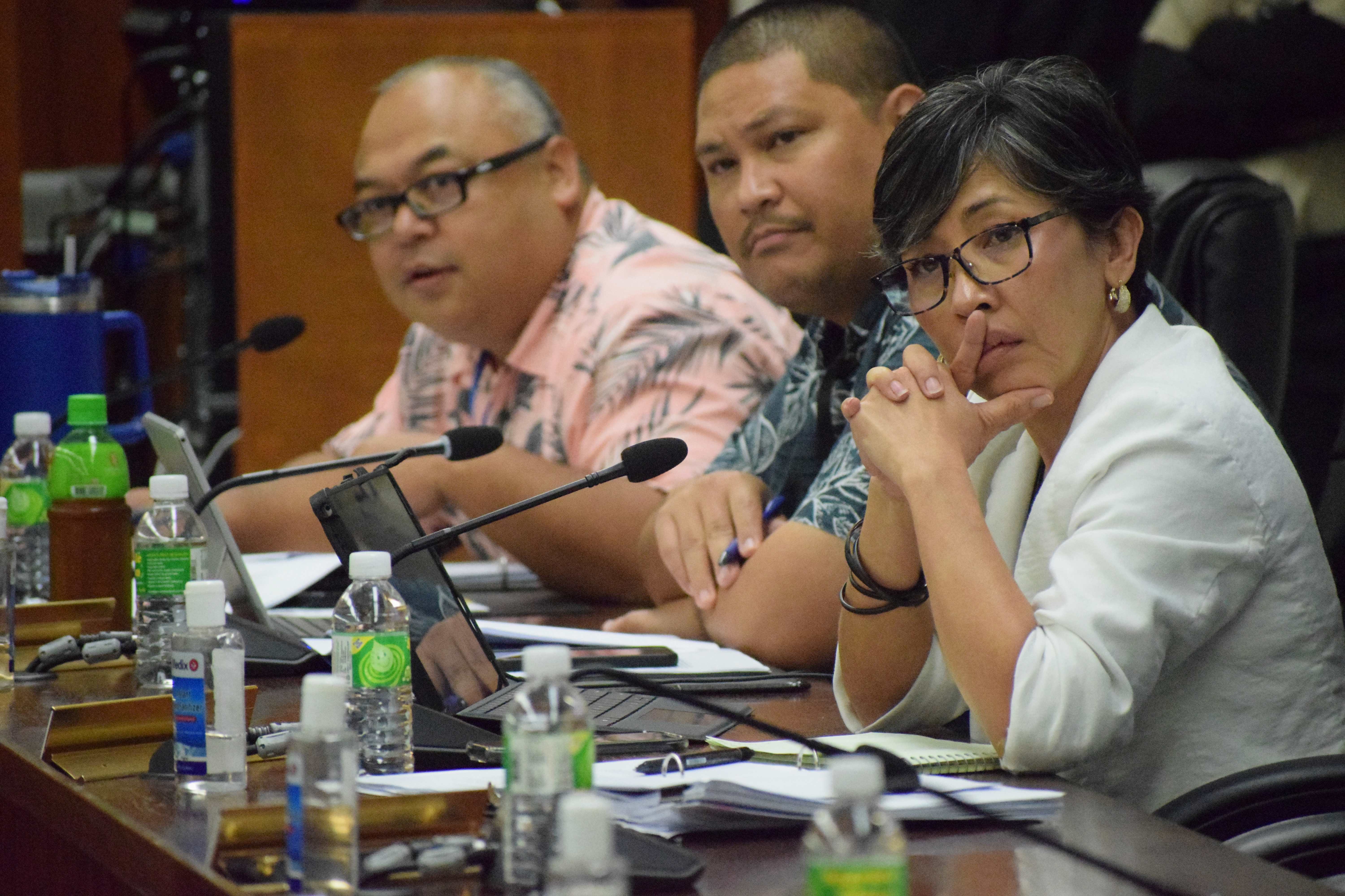 Rep. Diego Vincent Camacho, center, with Reps. Blas Jonathan Attao and Marissa Flores attend a meeting in the House chamber.  