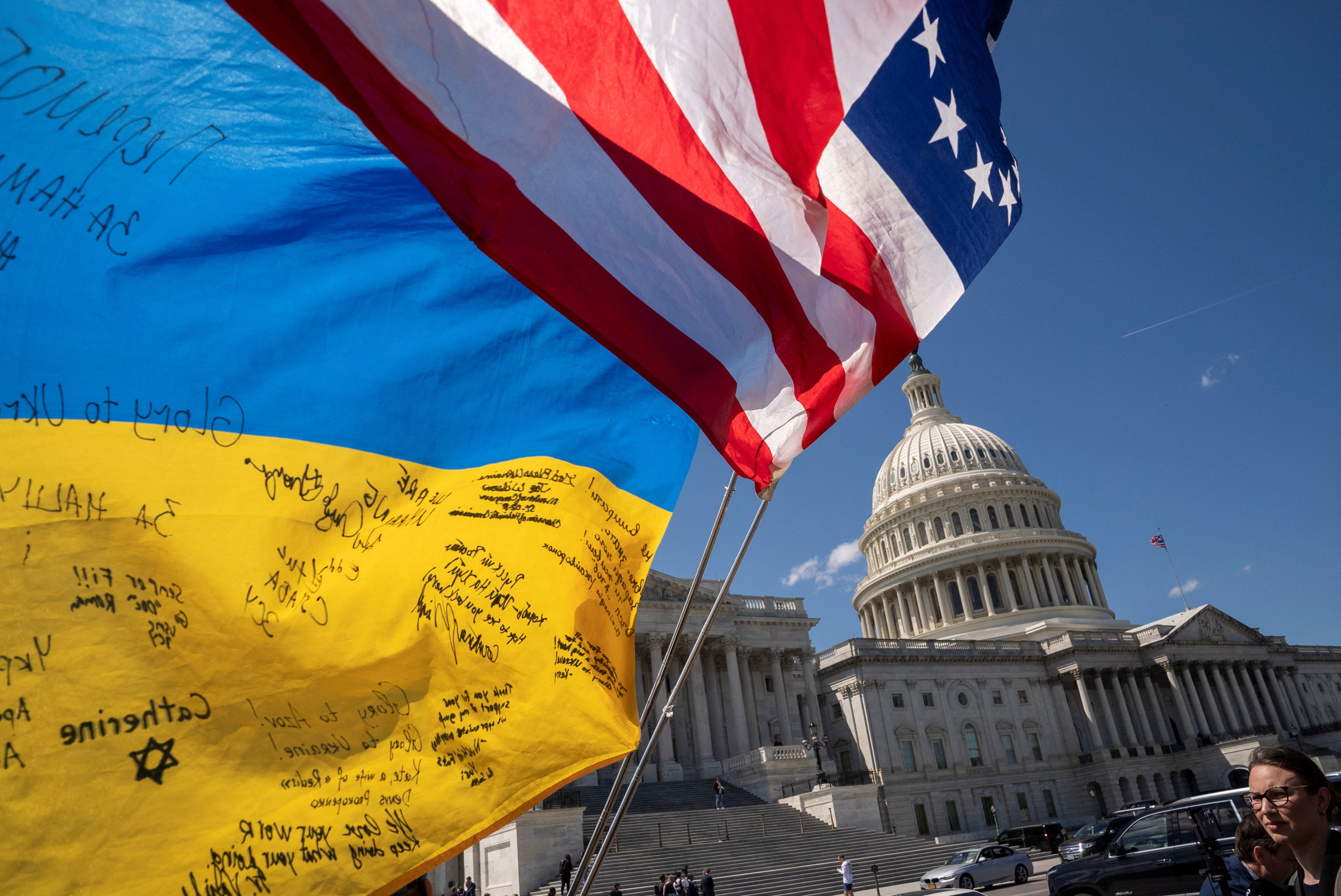 Flags flutter as pro-Ukrainian supporters demonstrate outside the U.S. Capitol, April 20, 2024.