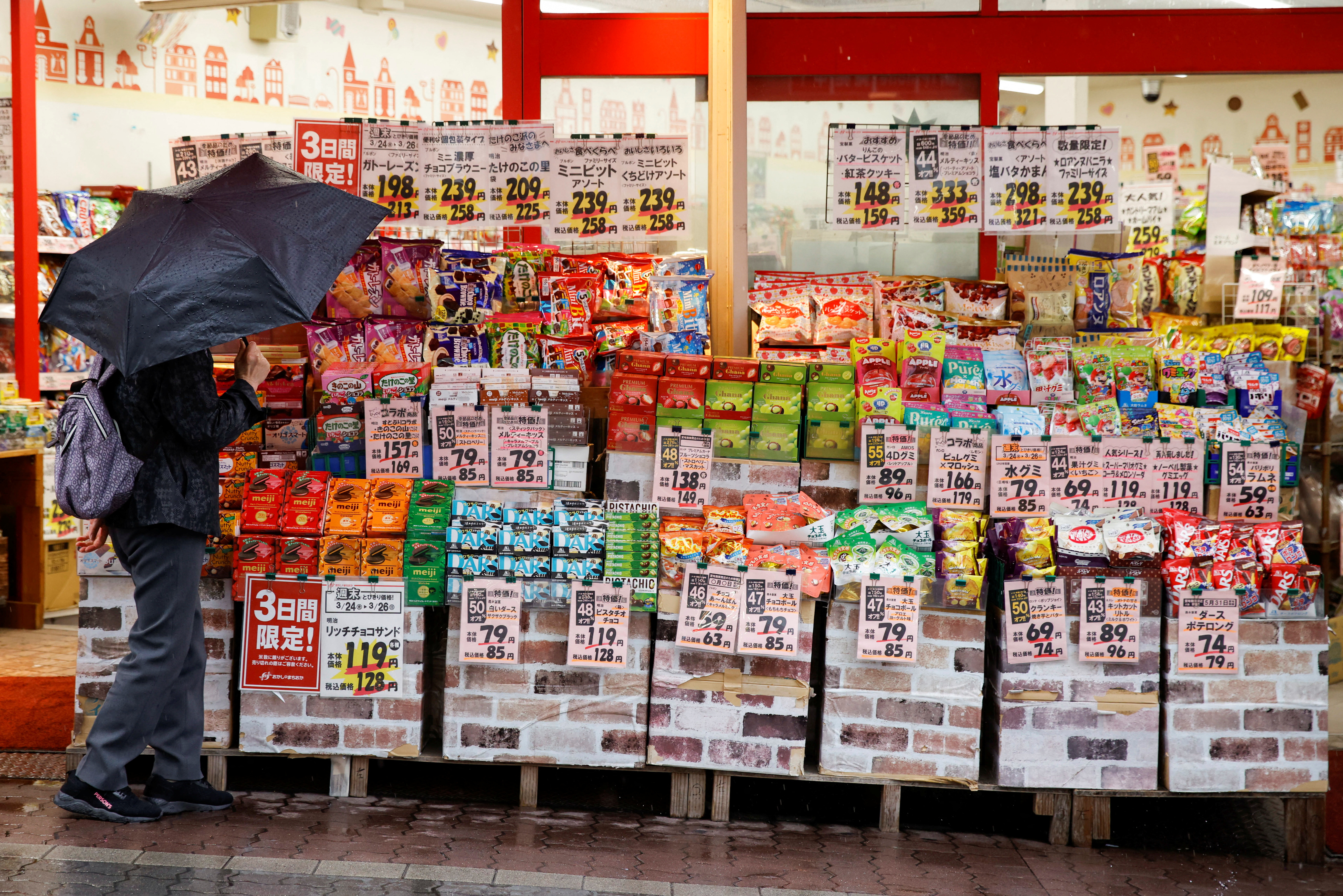 FILE PHOTO: A woman looks at items at a shop in Tokyo, Japan, March 24, 2023. 