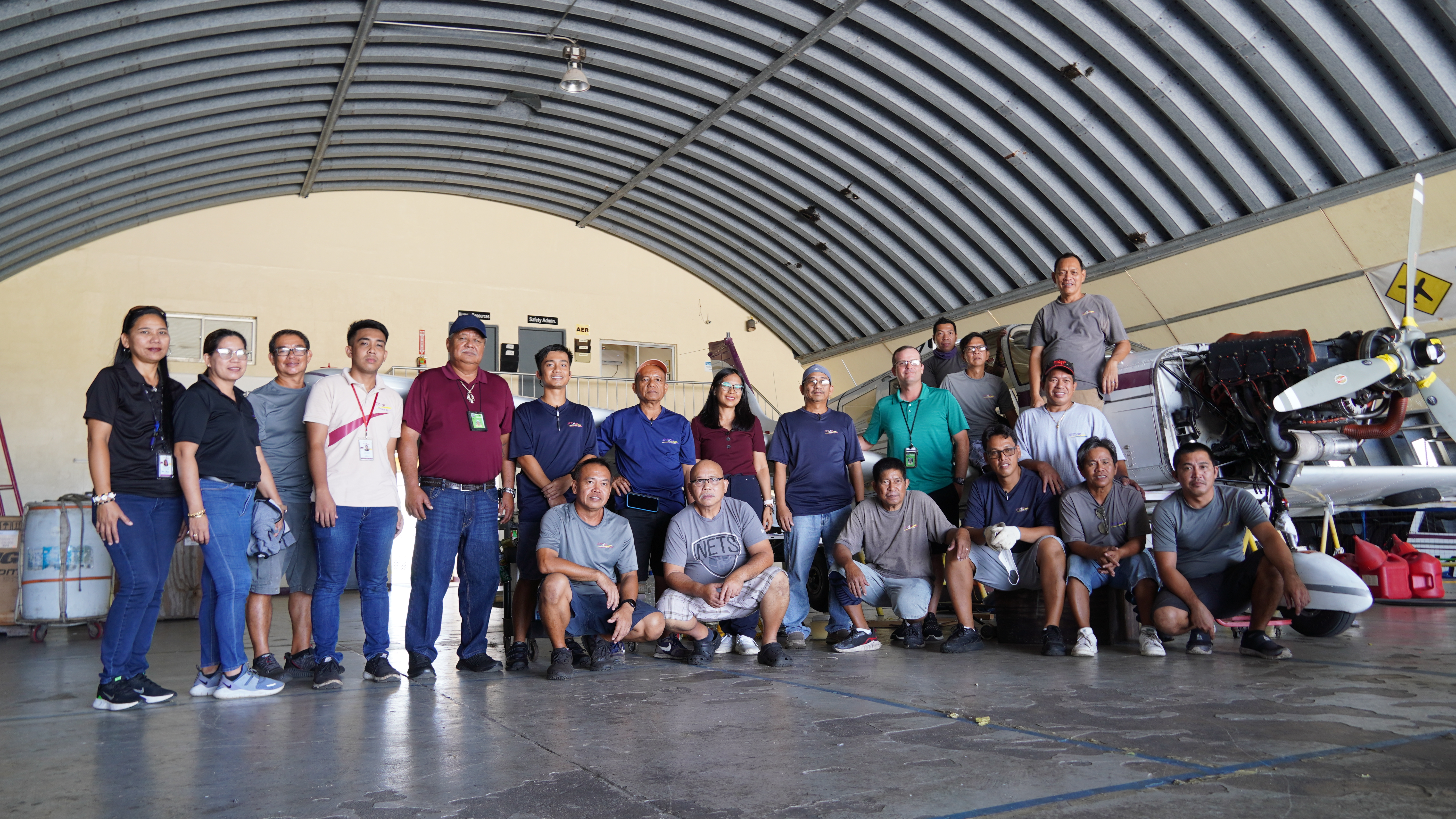 Shaun Christian (in green shirt) with SMA team in Tinian Hangar