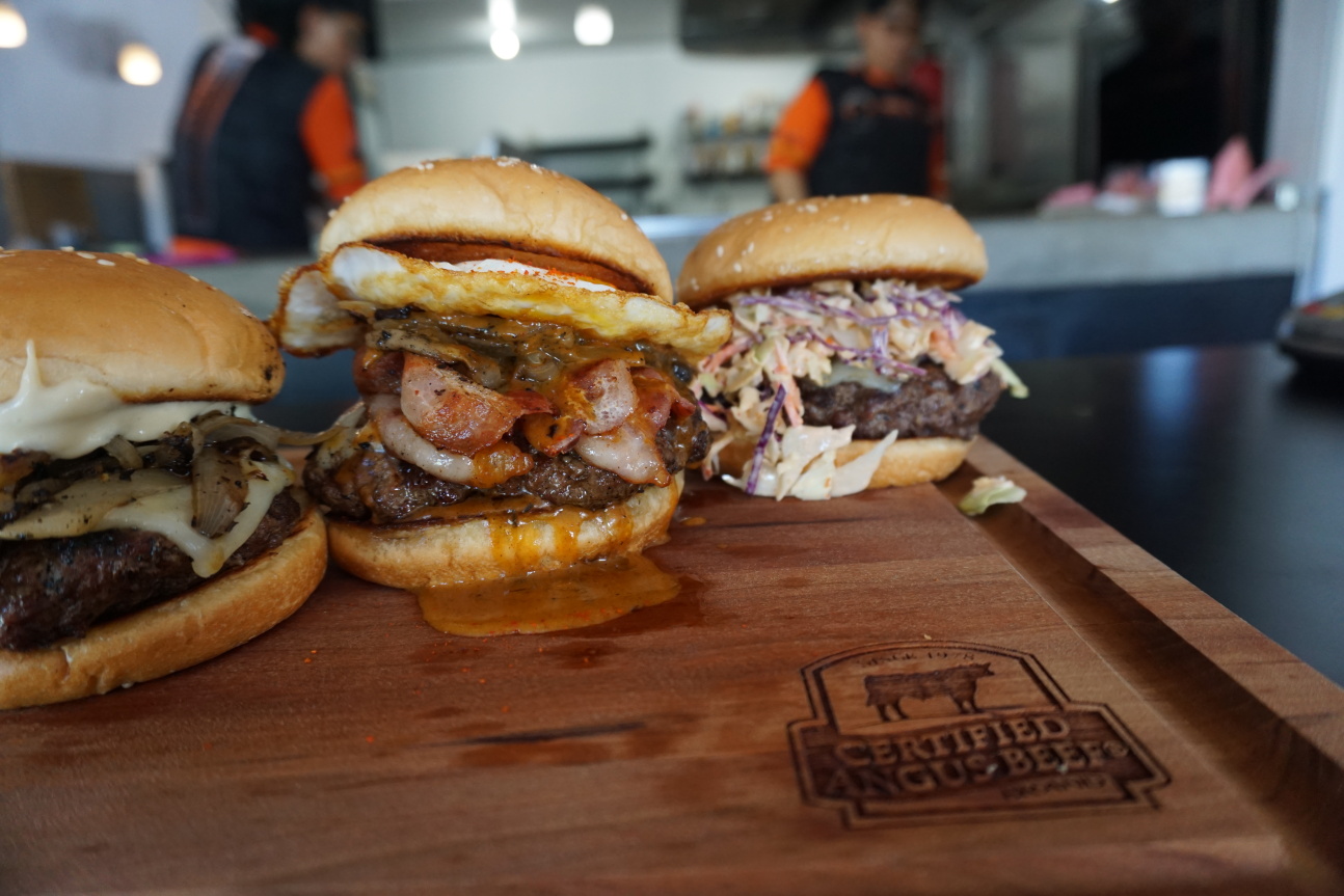 The Kaksaka Burger is a show stopper that features all kinds of heavy hitters. Next to it is the spicy slaw topped Pika Burger.​