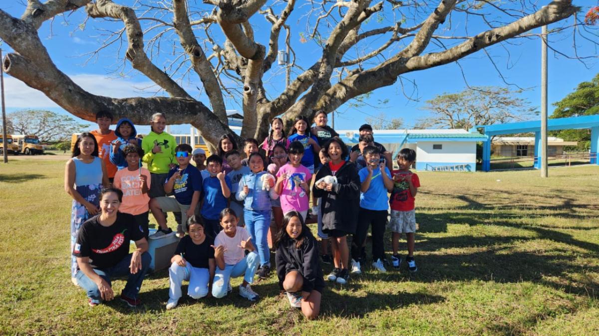 Fourth graders at Tinian Elementary School welcome presenters from the Marianas Tourism Education Council and the Marianas Visitors Authority to their school in San Jose, Tinian, on Feb. 14, 2025, to learn about tourism.