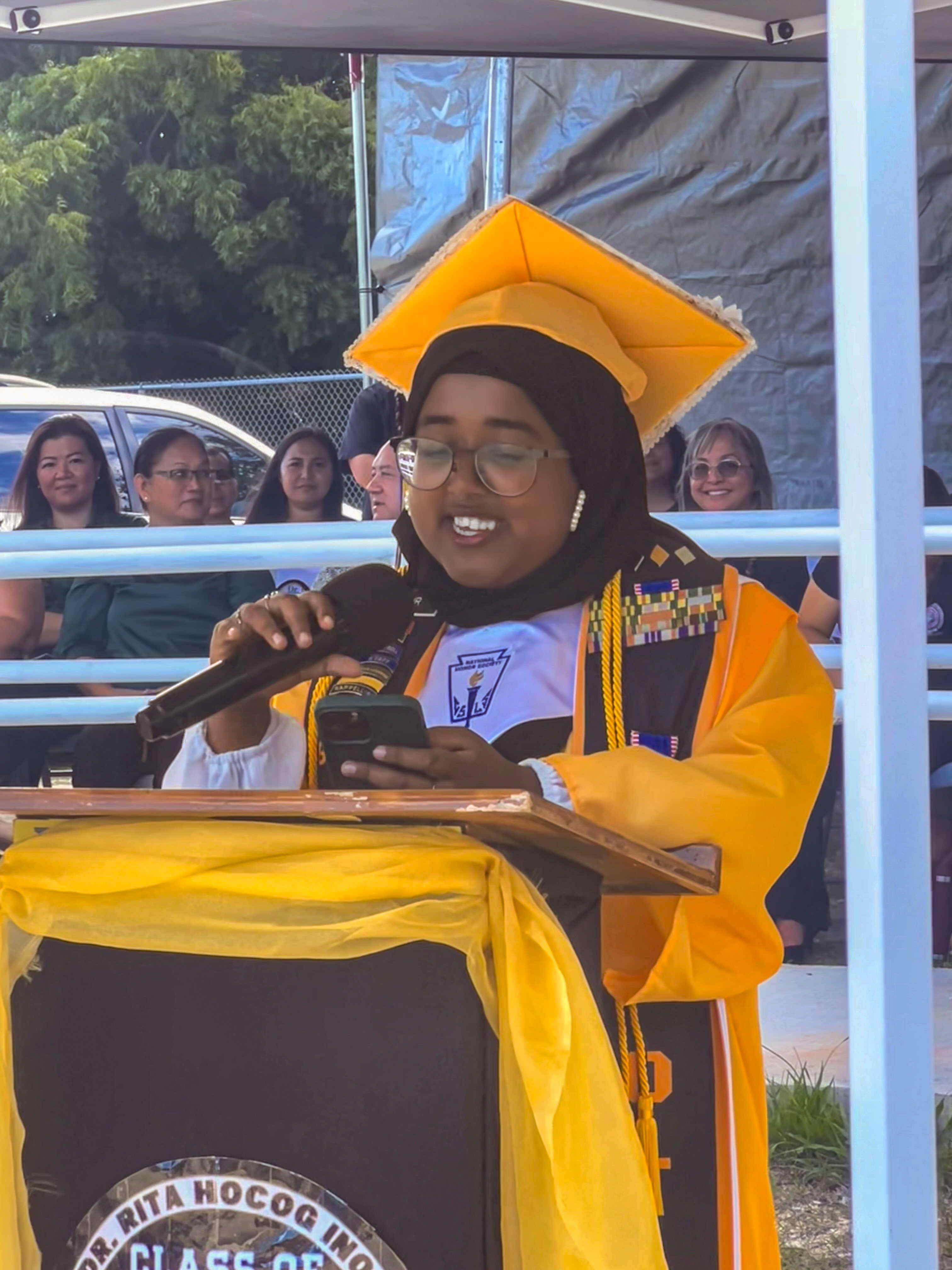 Class salutatorian Sayera Akter Sidur addresses the Rota community.