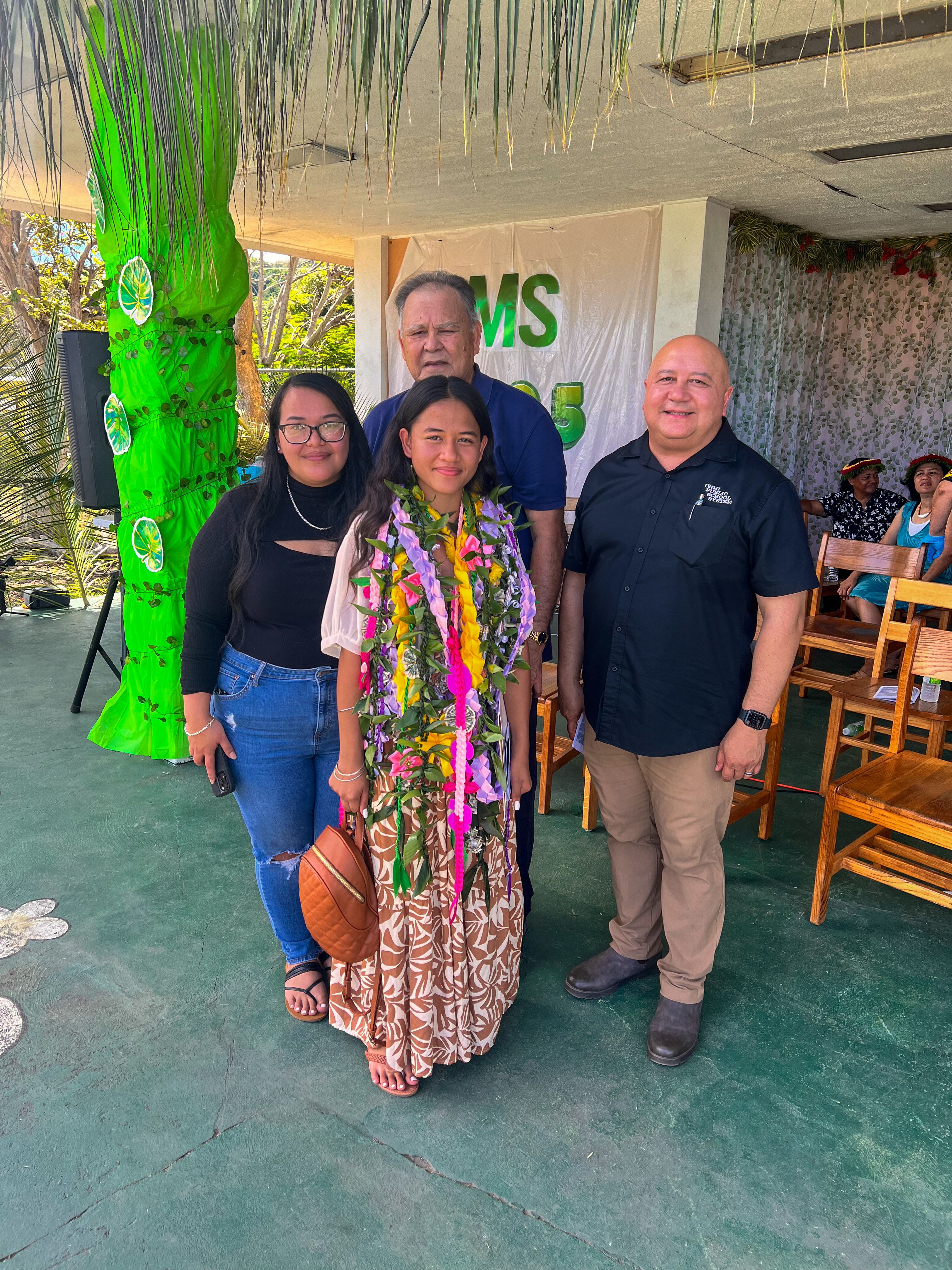 Commissioner of Education Dr. Lawrence F. Camacho with promoted student Callie Abraham and her family.