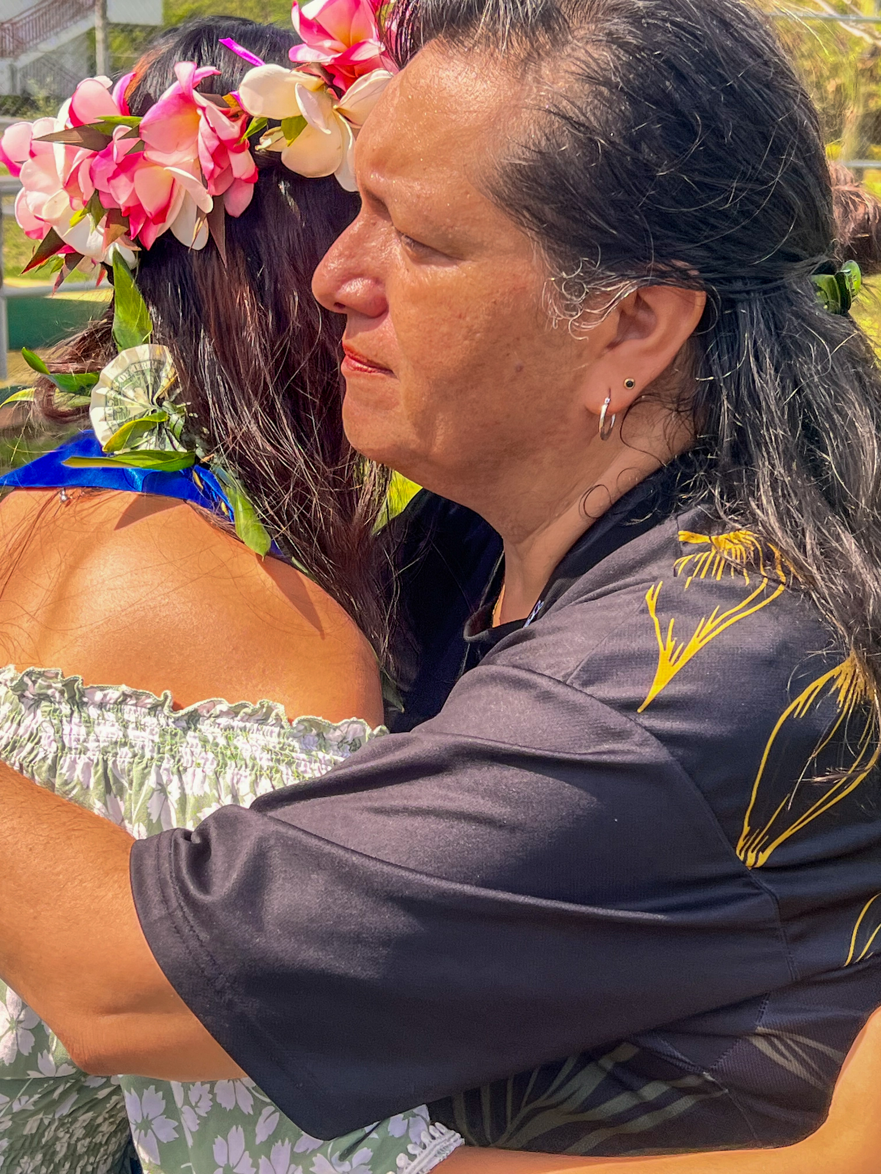 A TMS teacher hugs a promoted student.