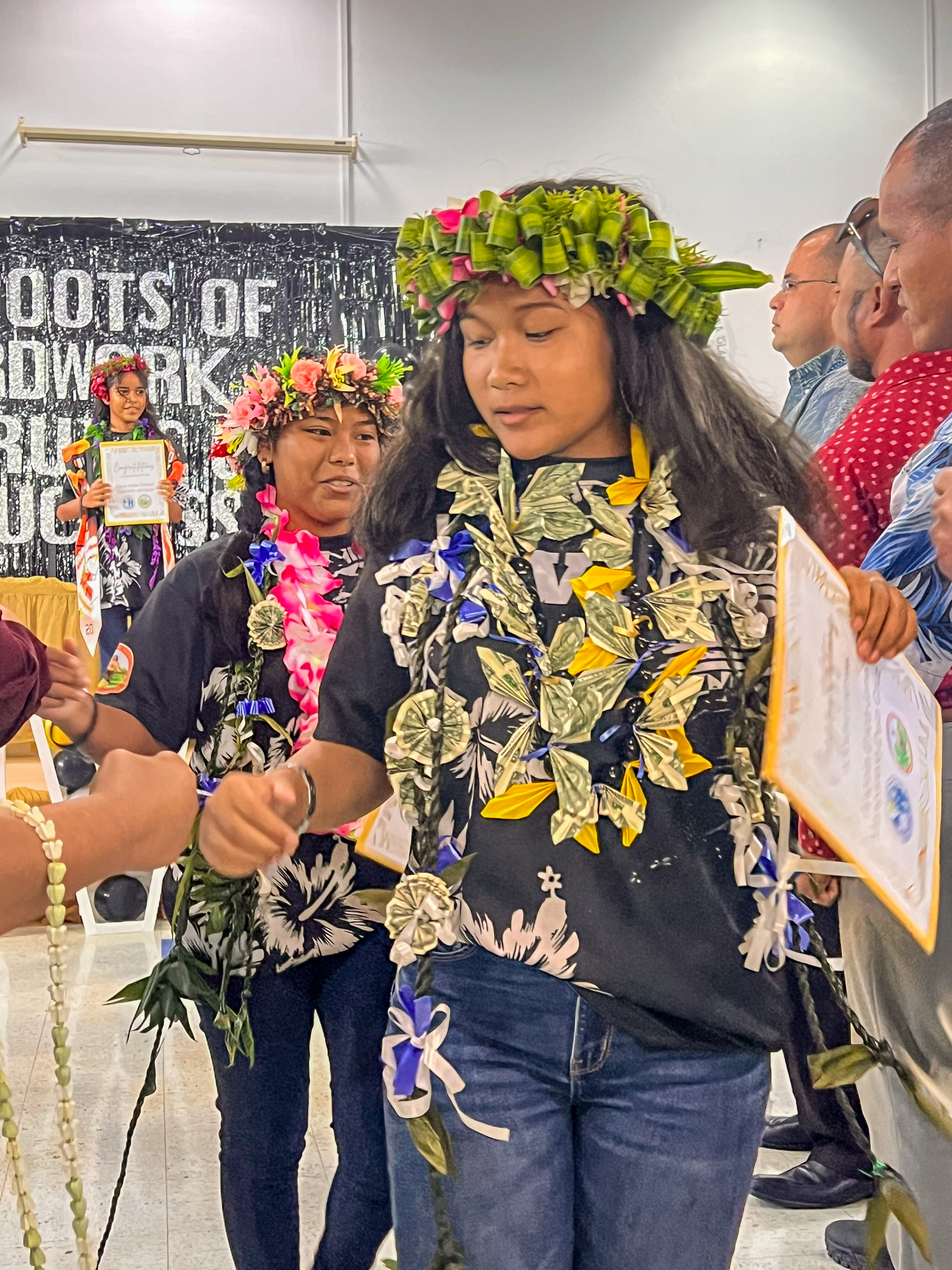 Promoted students are congratulated by education and government officials.